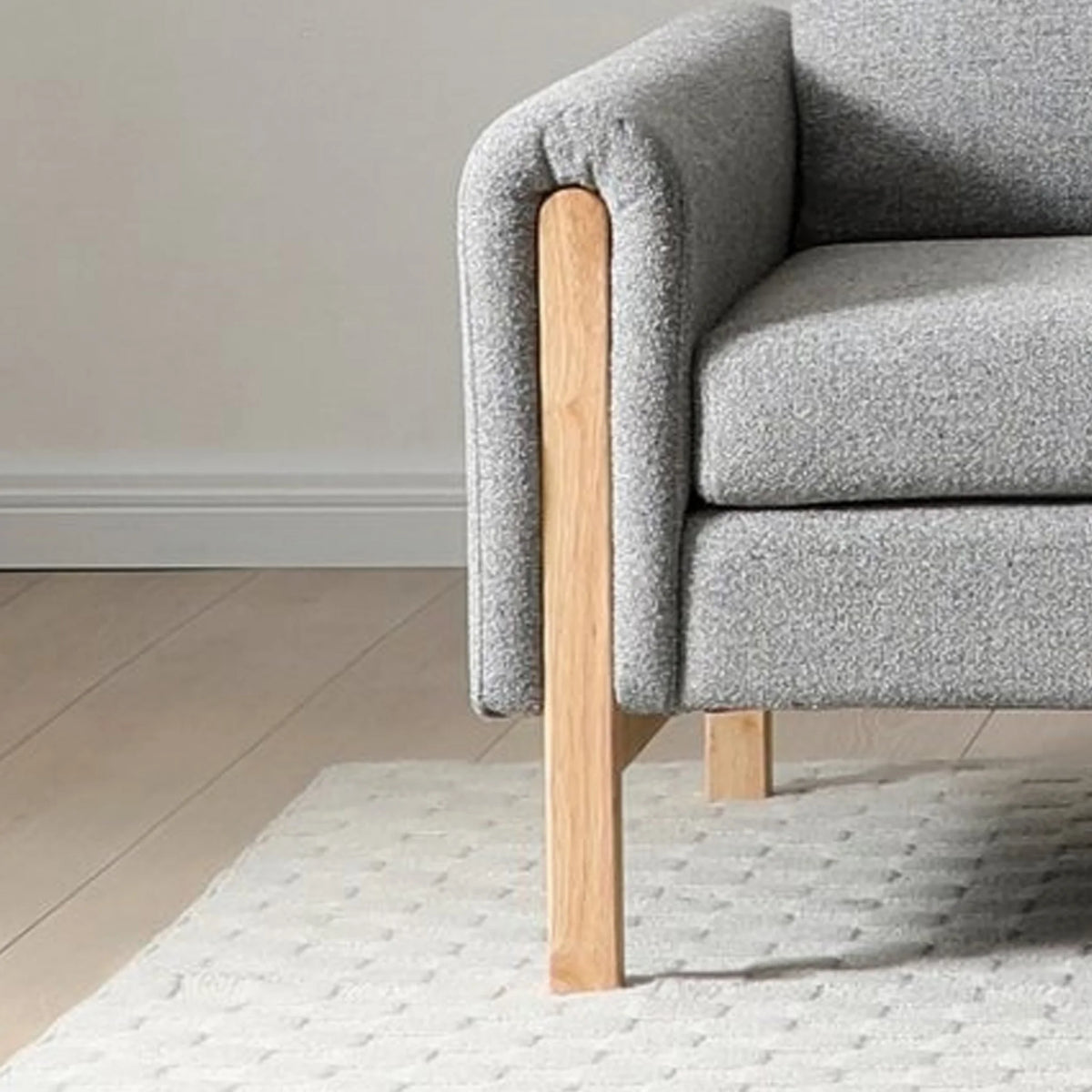 Thea Grey Upholstered Wood Sofa Bed – armrest and wooden leg detail
