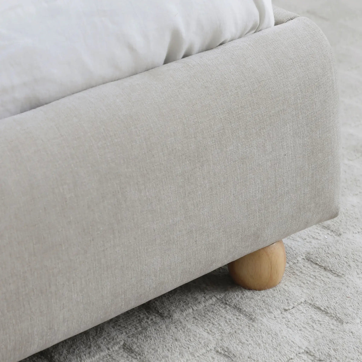 Mollie Oatmeal Upholstered Bed – frame and wooden leg detail close-up