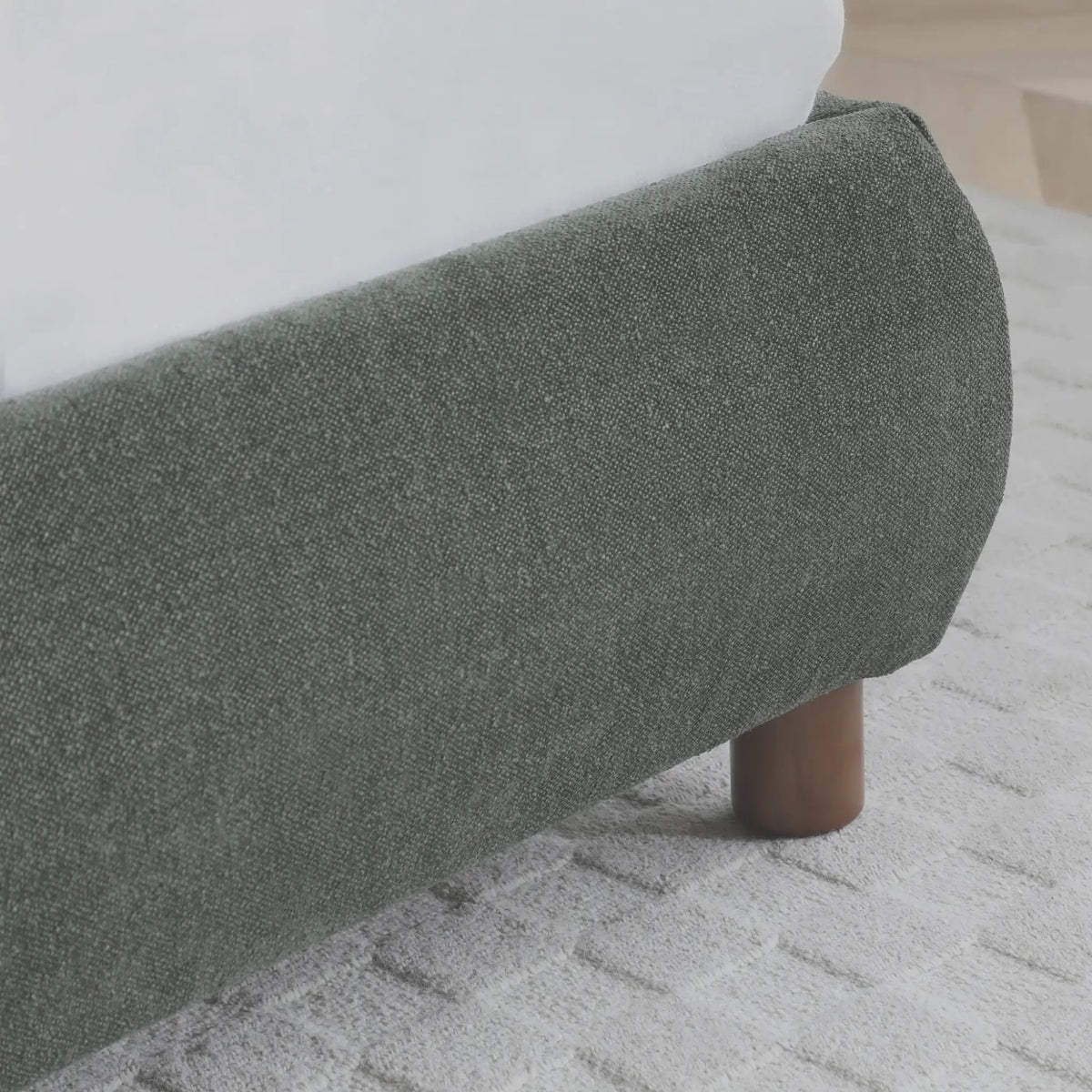Nora Olive Bouclé Bed – base corner and upholstery detail