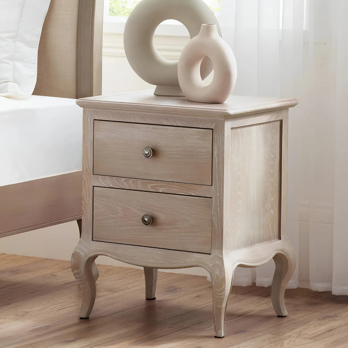 Camille Limed Oak 2-Drawer Bedside Chest – front view in room setting
