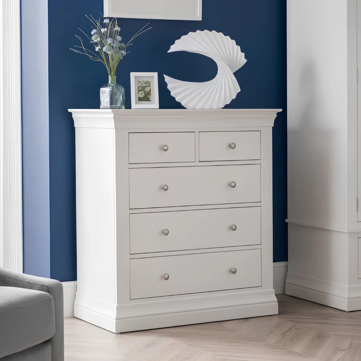 Clermont White Wooden 5-Drawer Chest – angled front and side view in room setting