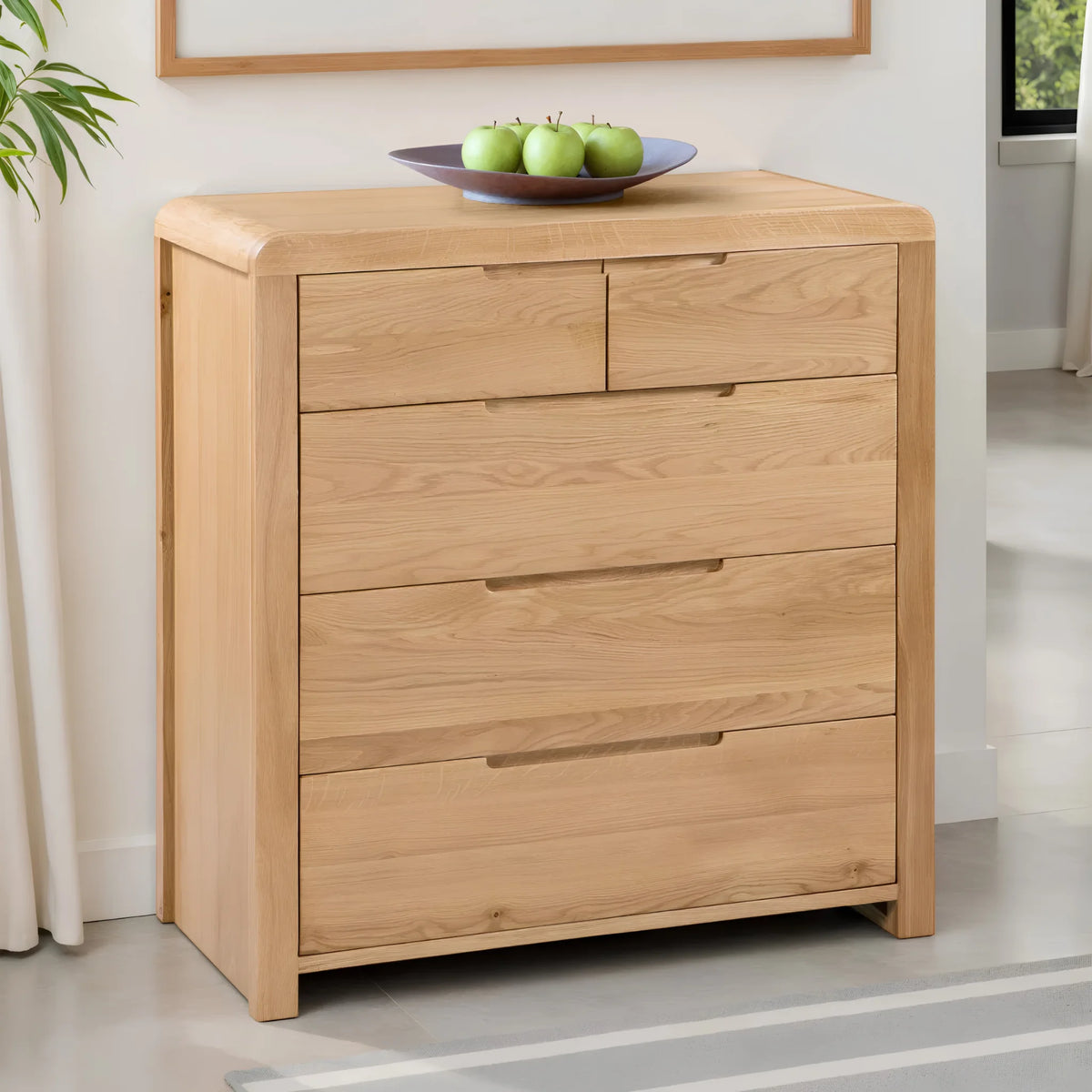 Curve Oak 5-Drawer Chest – angled front and side view in room setting