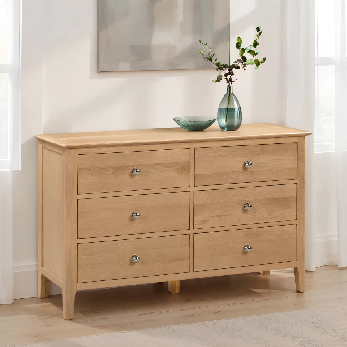 Cotswold Oak 6-Drawer Wide Chest – angled front and side view in room setting