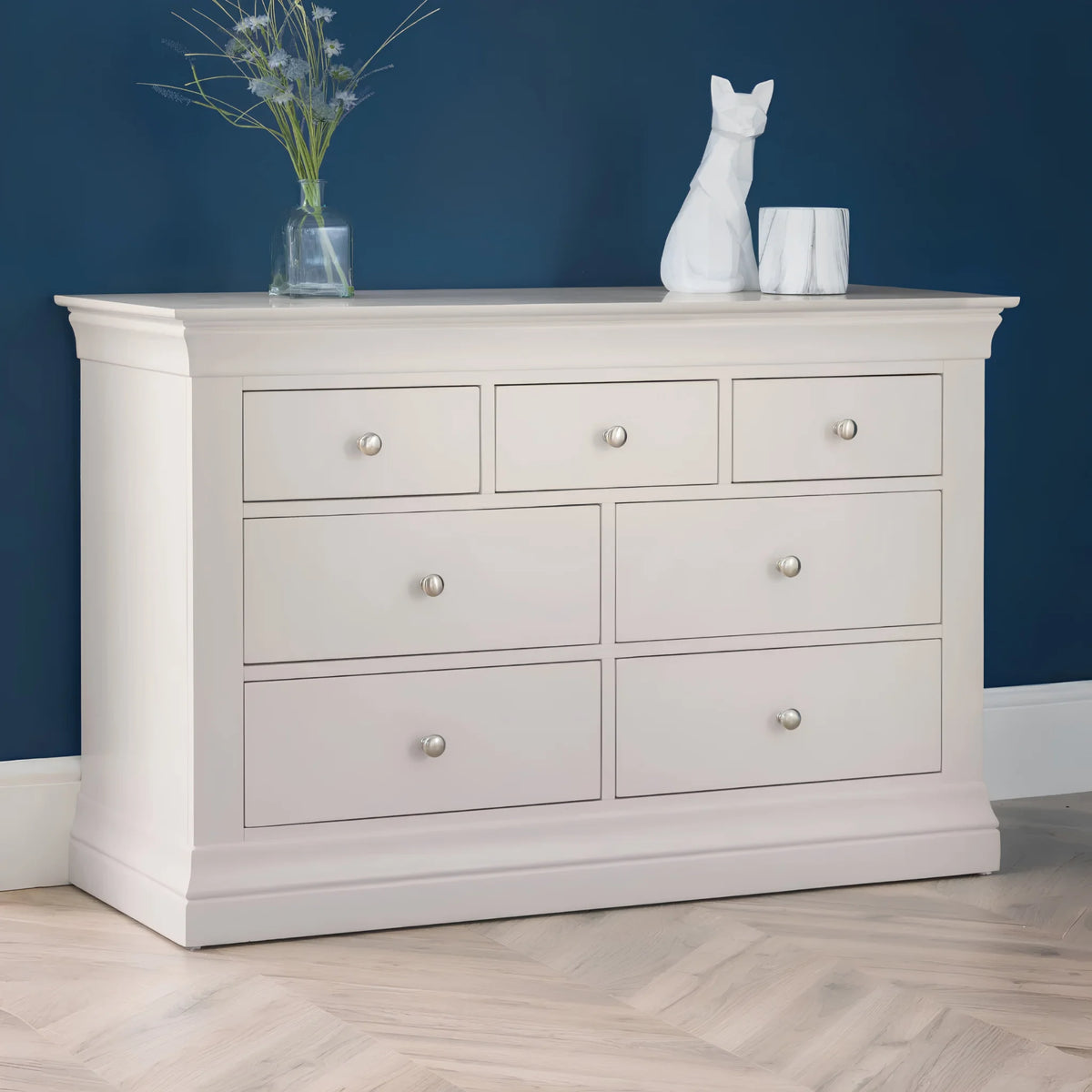 Clermont Grey Wooden 7-Drawer Chest – angled front and side view in room setting