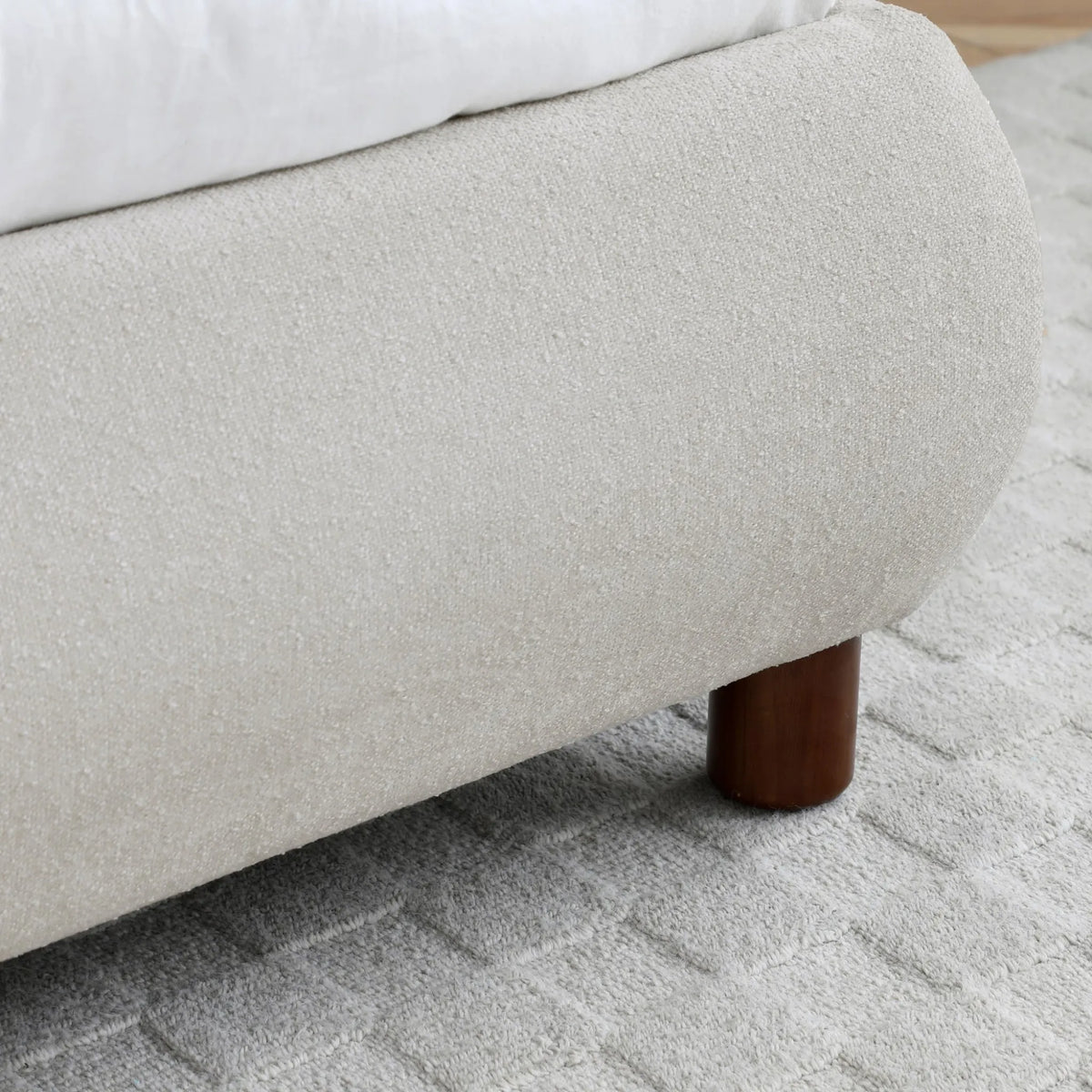 Nora Oatmeal Boucle Bed – close-up of upholstered base corner