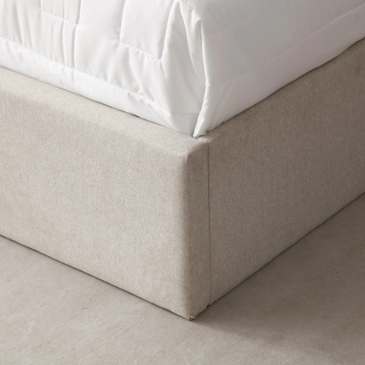 Denver Oatmeal Upholstered Ottoman Bed – close-up of upholstered base corner