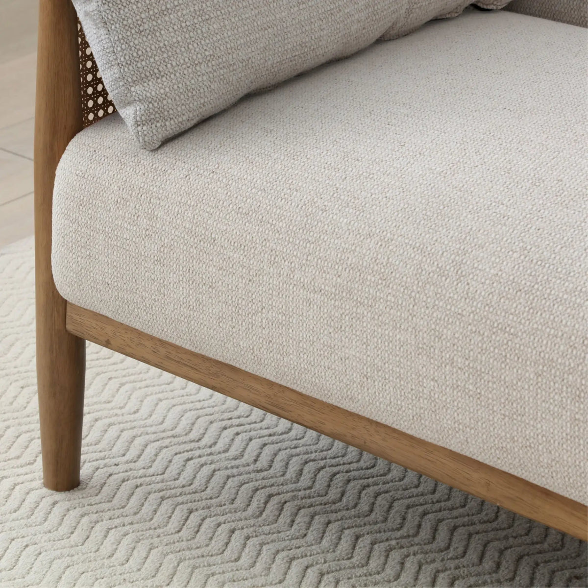 Zara Oatmeal Chenille Rattan Sofa Bed – close-up of chenille fabric and rattan side detail