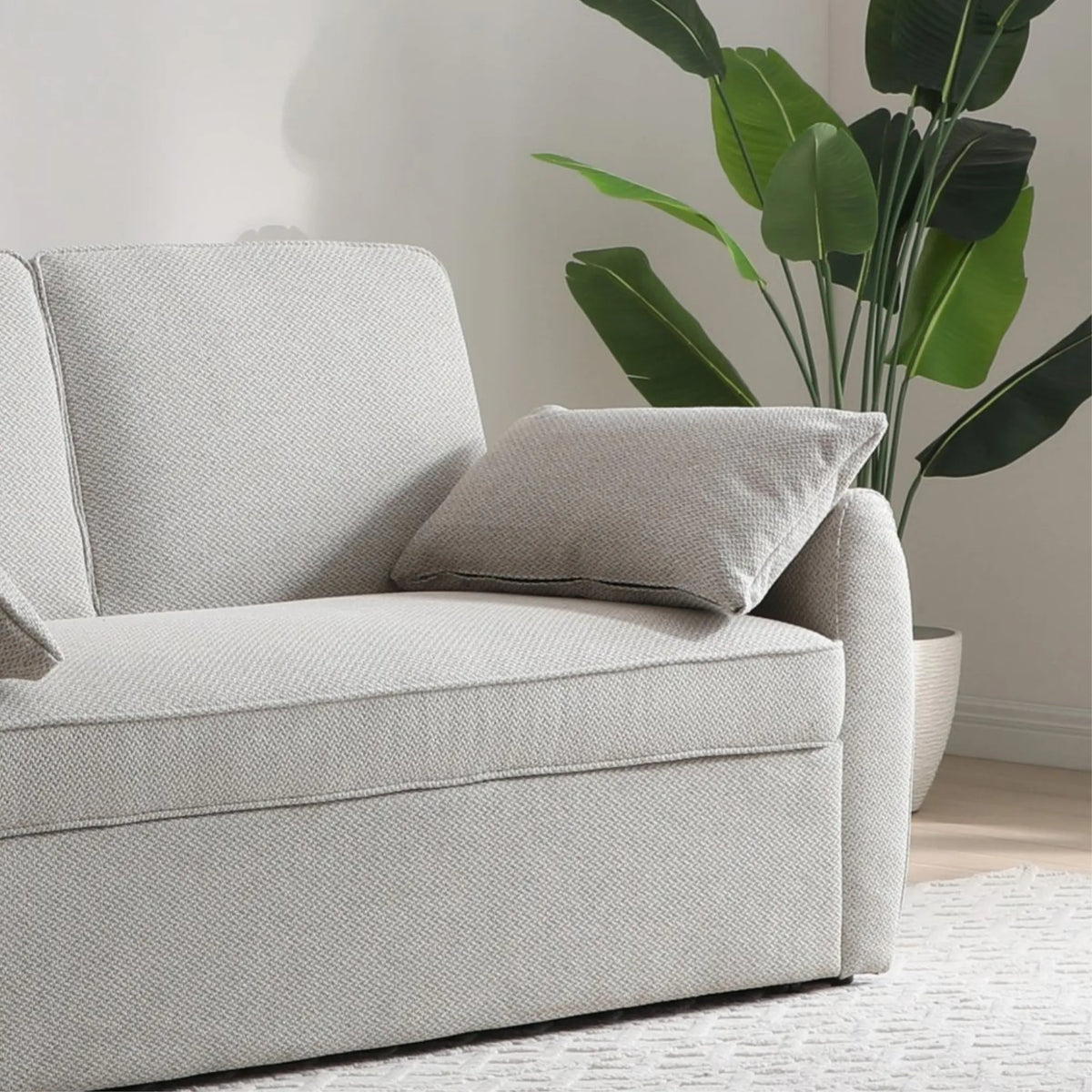 Clarke Oatmeal Sofa Bed – close-up of side armrest and decorative scatter cushion