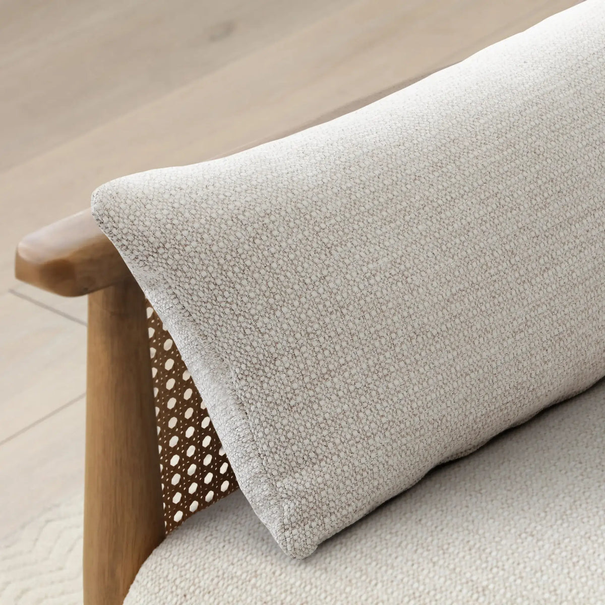 Zara Oatmeal Chenille Rattan Sofa Bed – close-up of chenille bolster pillow